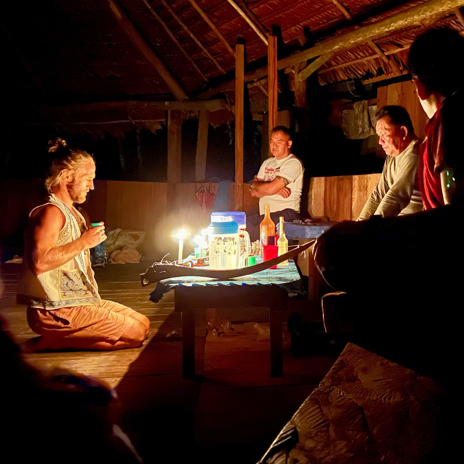 Receiving the medicine in ceremony, candlelit maloca